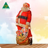 Cardboard cutout of Santa standing in front of a colourful background with the Australian Made logo